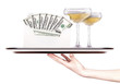 money in envelope on a tray with champagne and hand