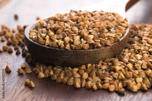 Photo: Buckwheat seeds on wooden spoon in closeup Buckwheat seeds on wooden spoon in closeup