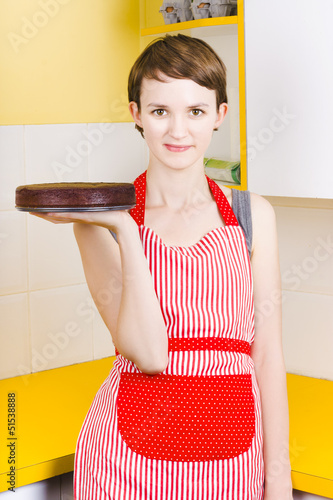 Photo: Woman in Red Apron with Chocolate Cake Woman in Red Apron with Chocolate Cake