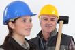 Construction worker with young female helper