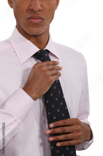 Photo: Businessman straightening his tie Businessman straightening his tie
