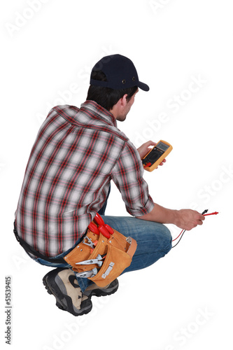 Photo: Electrician taking electrical reading Electrician taking electrical reading