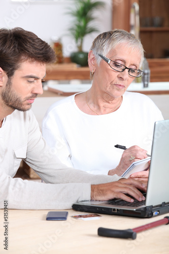 Photo: Man helping elderly lady Man helping elderly lady