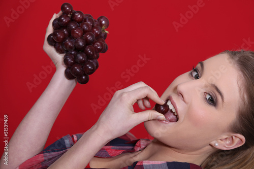 Photo: Woman eating grapes Woman eating grapes