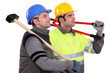 Two manual workers stood together looking into the distance