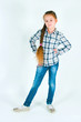 girl with long braid in a plaid shirt and jeans