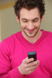 Young man smiling at his phone