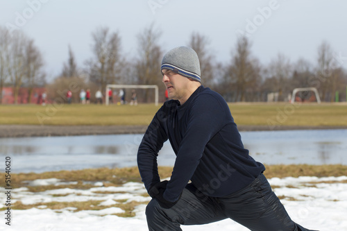 Photo: Athlete executes a variety of exercises at stadium Athlete executes a variety of exercises at stadium