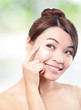 Beauty young woman applying cosmetic cream