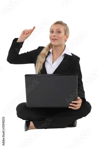 Photo: Blond businesswoman raising hand with question Blond businesswoman raising hand with question