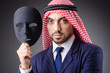 Arab with masks in dark studio
