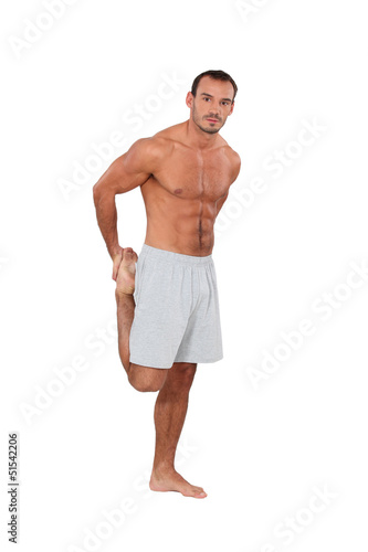 Photo: Muscular man doing gymnastics Muscular man doing gymnastics