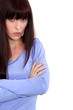 An unhappy woman with her arms crossed