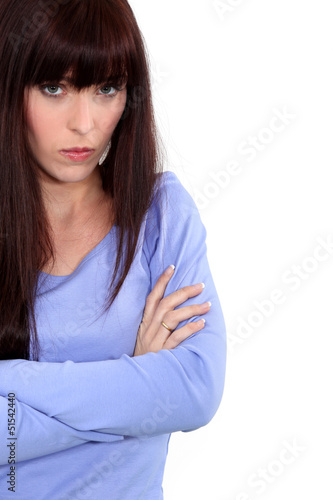 Photo: An unhappy woman with her arms crossed An unhappy woman with her arms crossed