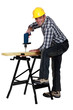 Man using a drill at a workbench
