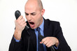 Photo: man shouting angrily in receiver man shouting angrily in receiver