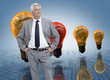 Businessman in front of colored light bulbs