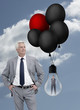 Businessman standing next to businesswoman inside light bulb