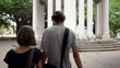 Young tourists, man and woman walking and holding hands