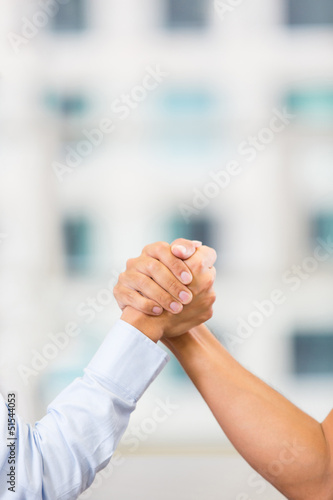 Photo: Business people arm wrestling Business people arm wrestling