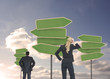 Rear view of businesspeople looking at empty signposts