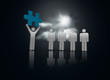 Foto: Character showing blue jigsaw piece to others Character showing blue jigsaw piece to others