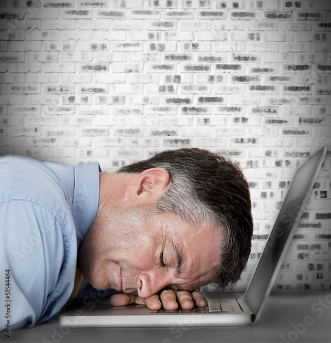 Photo: Businessman sleeping on his laptop Businessman sleeping on his laptop