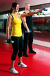 Foto: Couple working out in a fitness gym Couple working out in a fitness gym