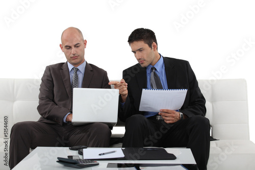 Photo: Two businessman working at home. Two businessman working at home.