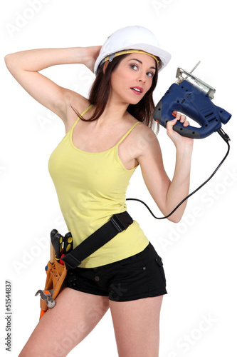 Photo: Woman holding electric saw Woman holding electric saw