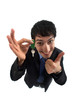 A businessman with a key giving a thumb up.