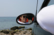 Young man in rearview mirror