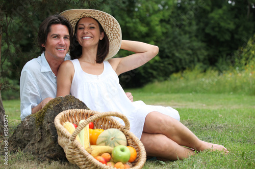 Photo: Couple having vegetarian picnic. Couple having vegetarian picnic.