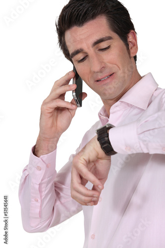 Photo: Businessman consulting his watch Businessman consulting his watch