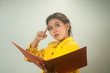 Pretty Asian businesswoman ruminated  and holding a file .