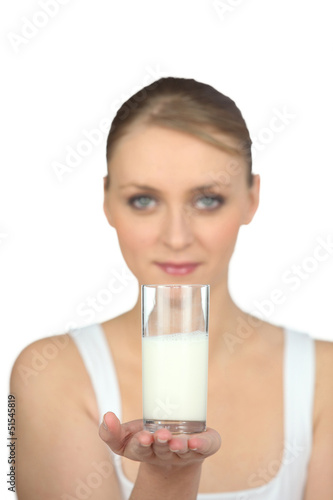 Photo: Woman holding a glass of milk Woman holding a glass of milk