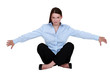 A businesswoman seated on the floor.