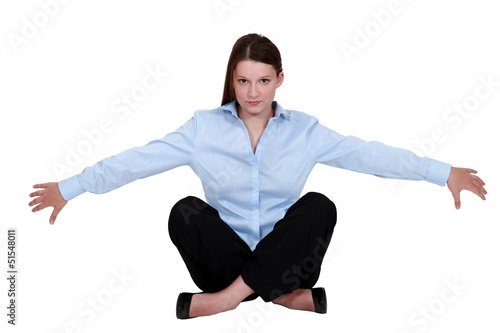 Photo: A businesswoman seated on the floor. A businesswoman seated on the floor.