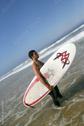 Photo: Man going surfing Man going surfing