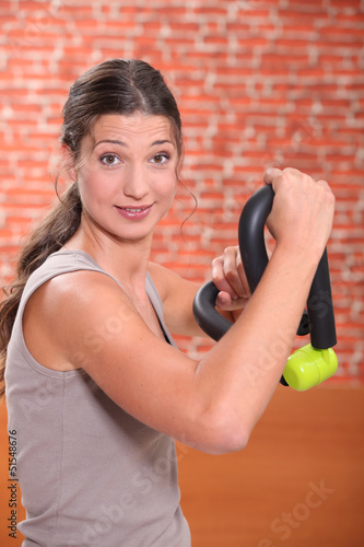 Photo: Woman doing weight training Woman doing weight training