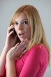 Photo: blonde on the phone gossiping with friend blonde on the phone gossiping with friend