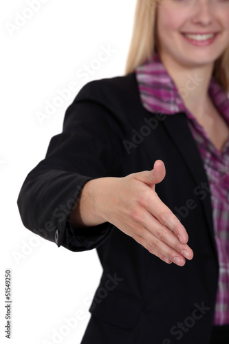 Photo: Woman holding her hand out for a handshake Woman holding her hand out for a handshake