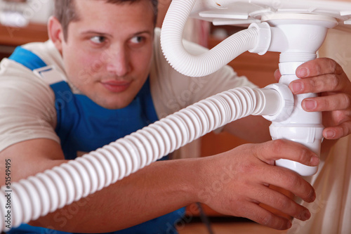 Photo: Plumber fixing a sink Plumber fixing a sink
