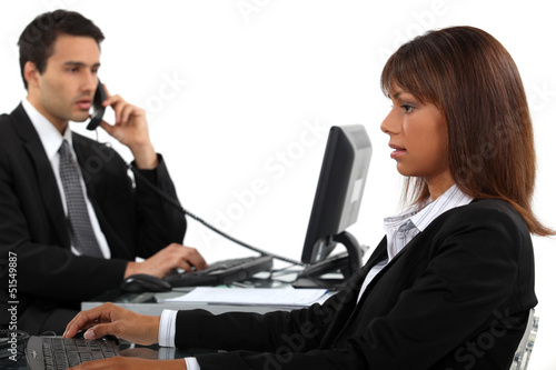 Photo: Two businesspeople hard at work Two businesspeople hard at work