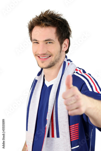 Photo: football fan making a thumbs up sign football fan making a thumbs up sign