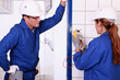 Photo: Male electrician supervising female apprentice Male electrician supervising female apprentice