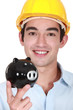 Builder holding piggy-bank