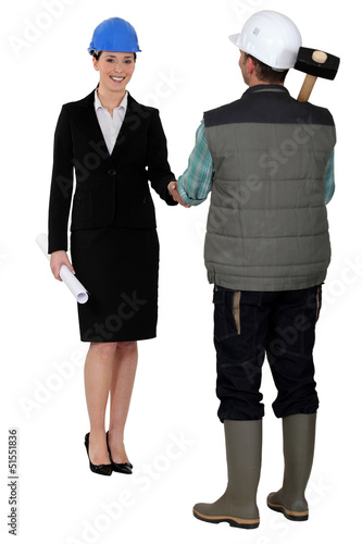 Photo: Builder and businesswoman shaking hands Builder and businesswoman shaking hands