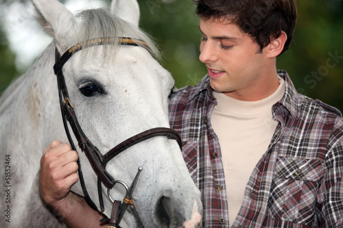 Photo: Young man with a horse Young man with a horse