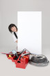 Woman electrician behind white panel